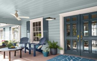 Light blue porch with navy double doors