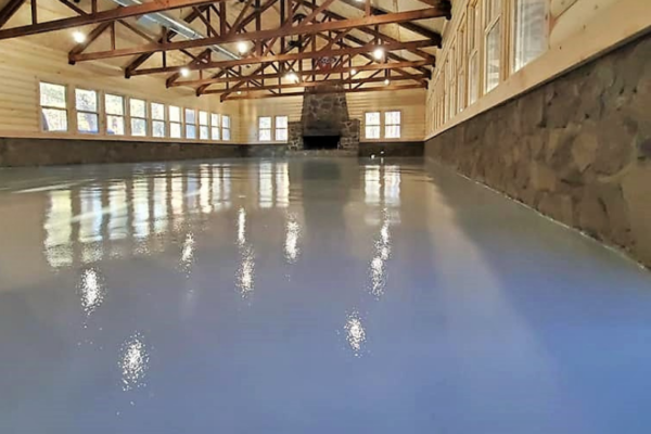 A large room with many windows and ceiling beams.